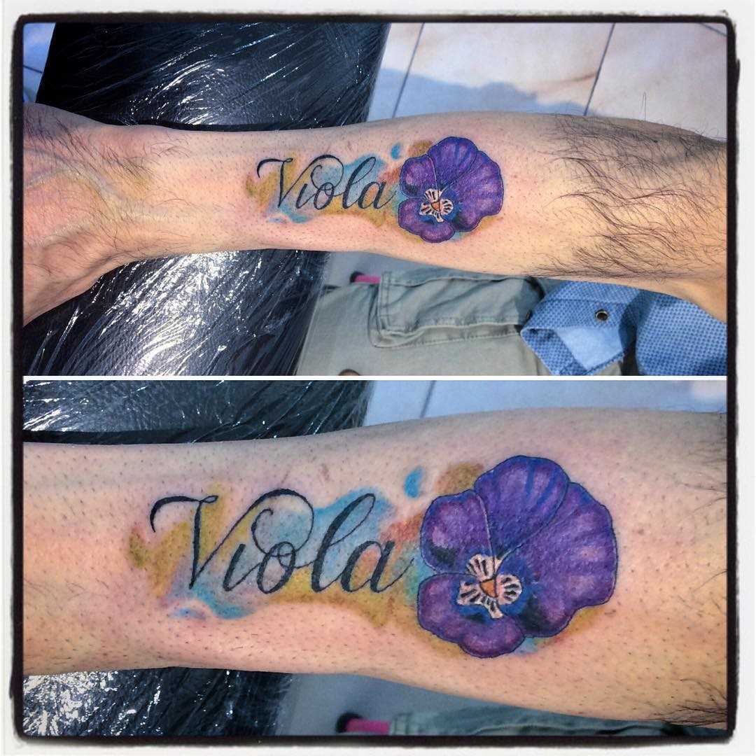 A foto da tatuagem de violeta com a inscrição no antebraço cara