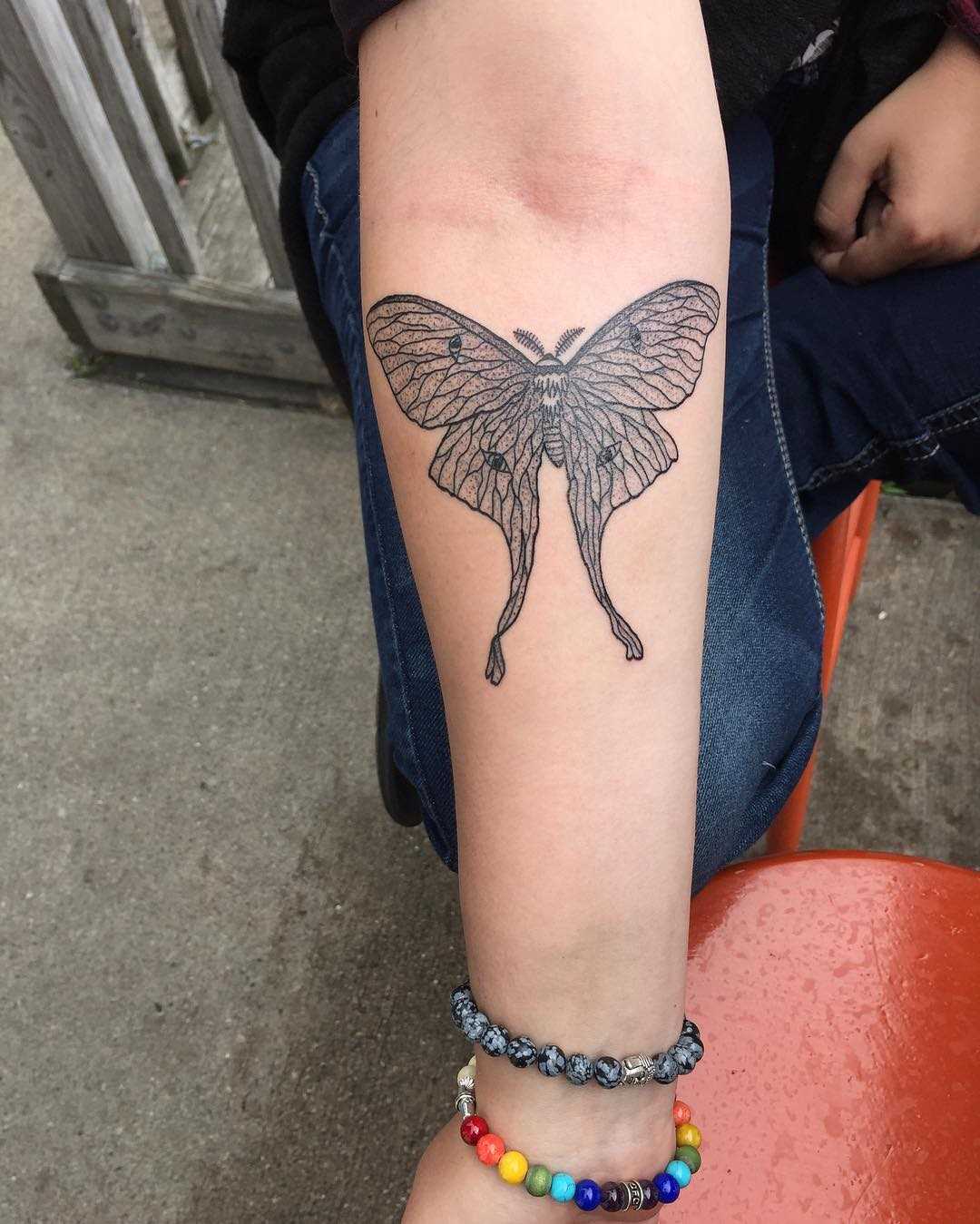 A tatuagem de inseto no antebraço da menina