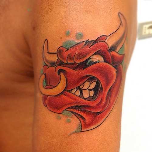 A tatuagem do cara no ombro com a imagem da cabeça de um touro