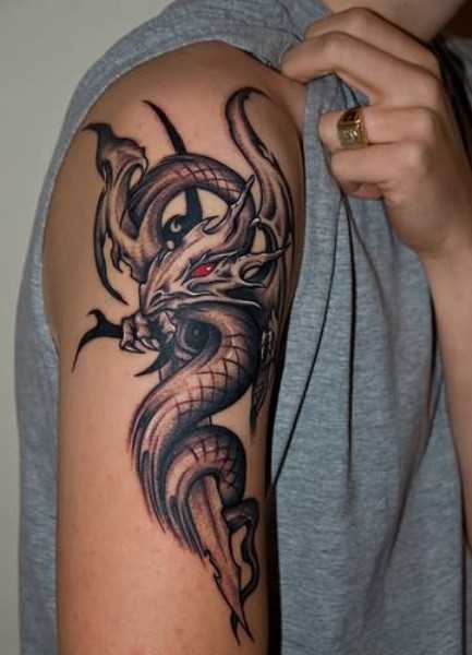 A tatuagem do cara no ombro em forma de dragão com olhos vermelhos