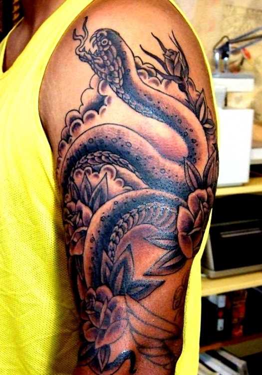 A tatuagem em forma de serpente no ombro da menina