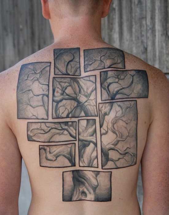 A tatuagem nas costas do cara - de quebra-cabeça em forma de pintura com a árvore