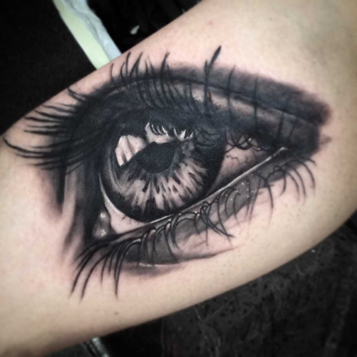 A tatuagem no braço de uma menina de olho