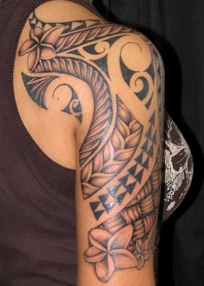 A tatuagem no estilo tribal no braço da menina - padrões com cores