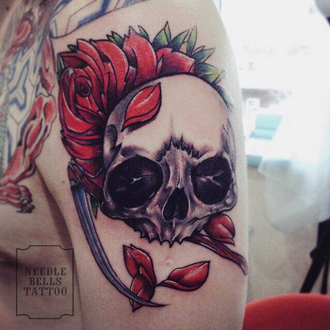 A tatuagem no ombro de um cara - de caveira e flor