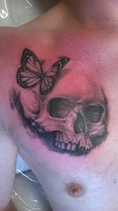 A tatuagem no peito do cara de crânio e uma borboleta