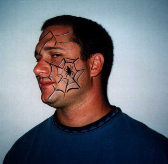 A tatuagem no rosto de um cara - de- teia de aranha e a aranha