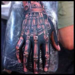A tatuagem nos dedos de um cara no estilo de biomecânica