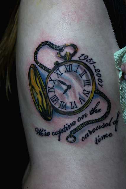 Bela tatuagem no lado da menina - relógio de bolso e legenda em inglês
