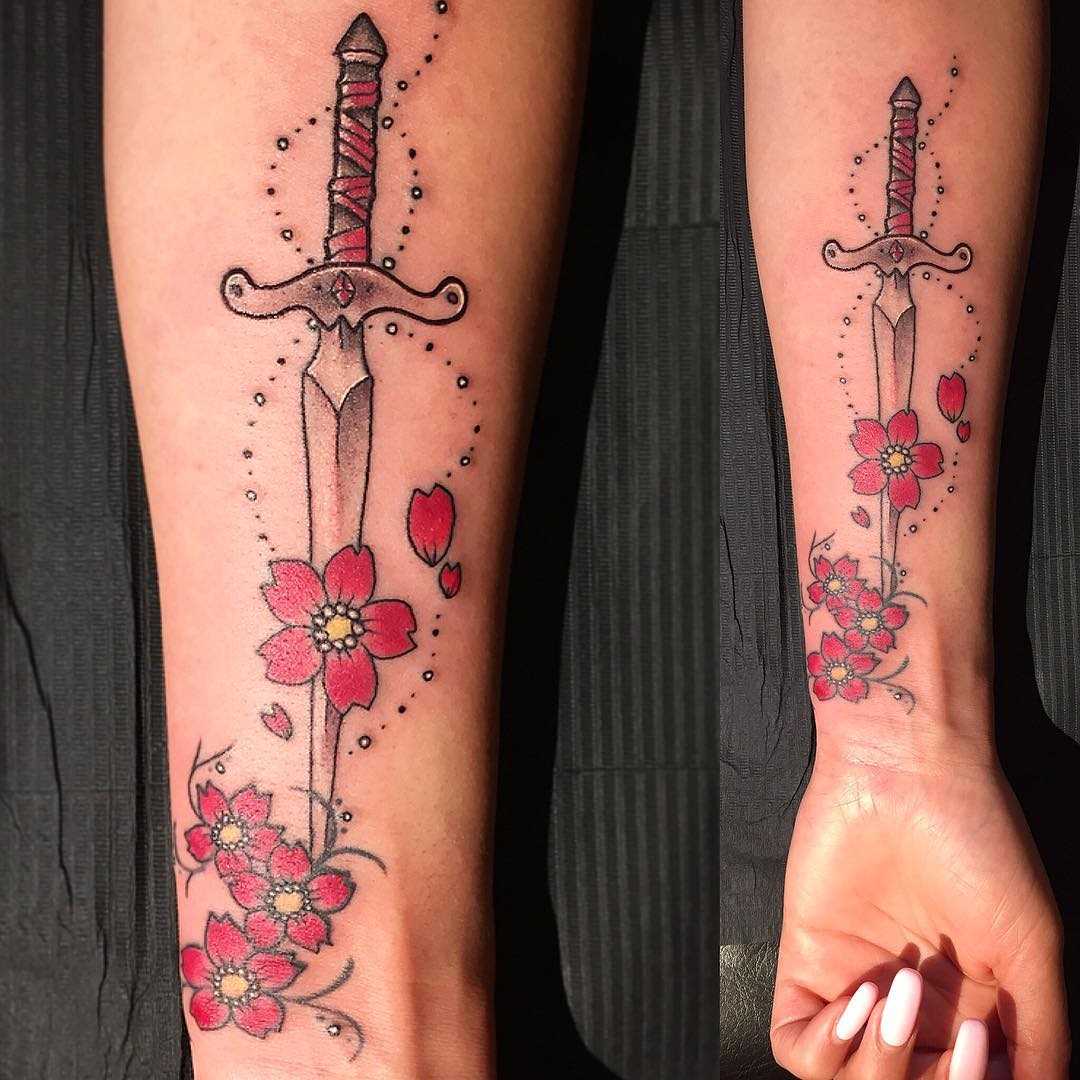 Desenho de uma espada com flores no antebraço da menina