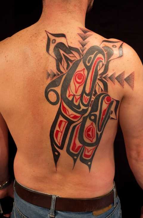 Foto de uma tatuagem no estilo de haida nas costas do cara