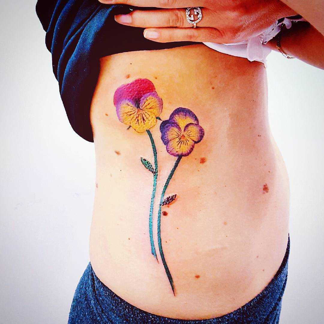 Fotos de tatuagem de violetas no lado de meninas