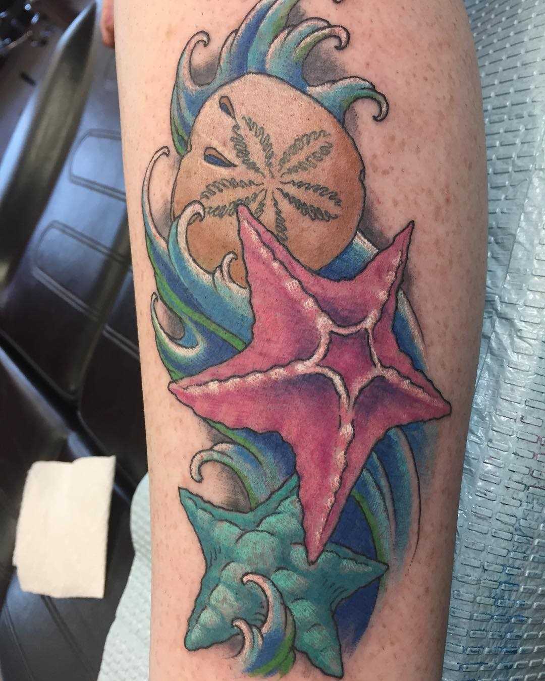 Linda tatuagem de estrelas do mar sobre a perna da menina