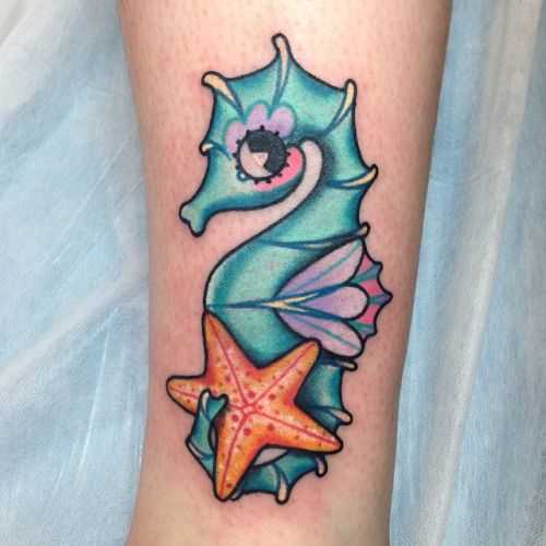 Tattoo do cavalo-marinho sobre a perna da menina