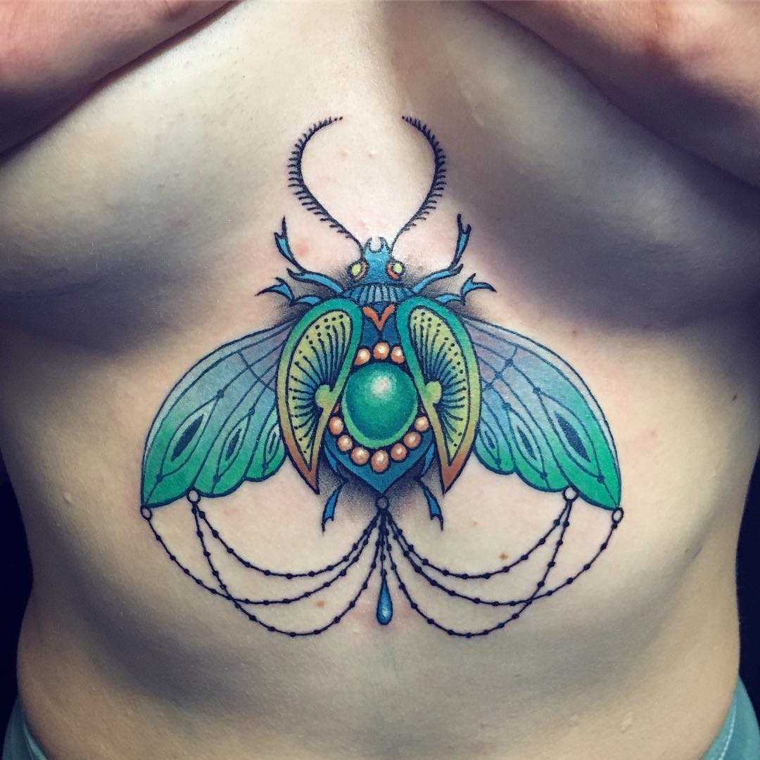 Tatuagem de escaravelho no peito da menina