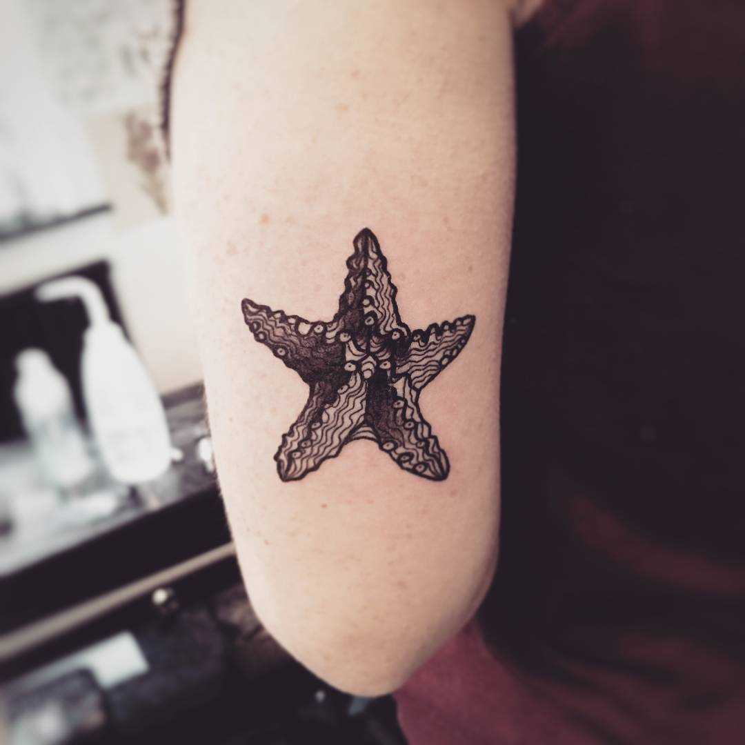 Tatuagem de estrela na mão da mulher
