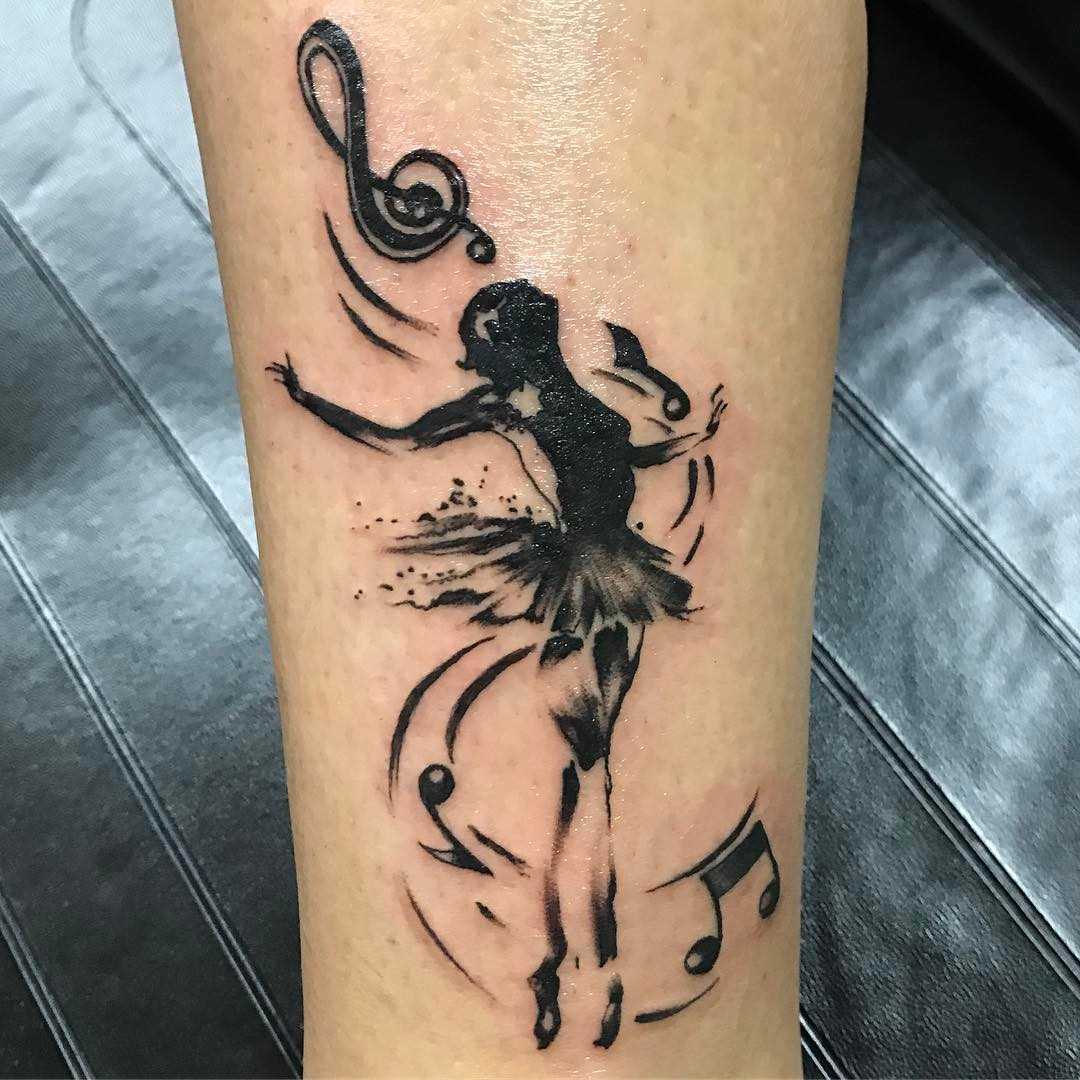 Tatuagem de uma bailarina sobre a perna da mulher