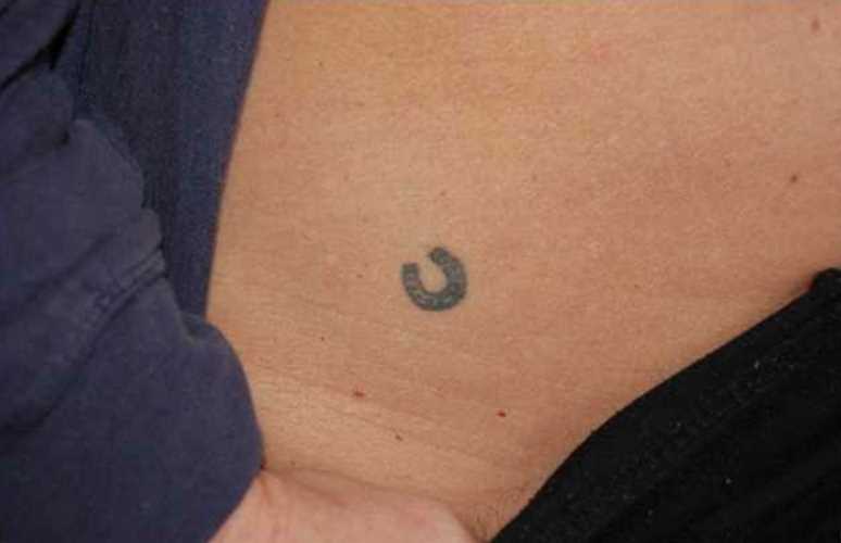 Tatuagem na barriga da menina - pequena ferradura