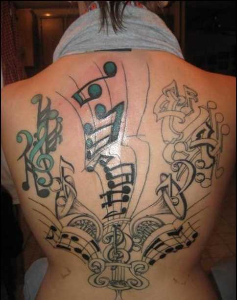 Tatuagem nas costas de uma menina notas e violin chaves