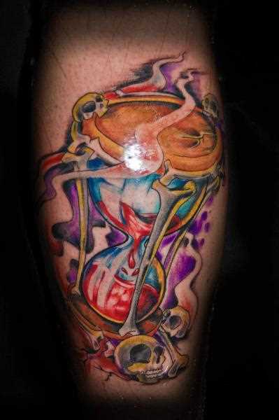Tatuagem no braço de um cara - a ampulheta, o crânio e os ossos