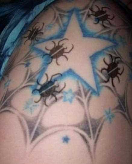 Tatuagem no ombro da menina - teia de aranha, a estrela e besouros