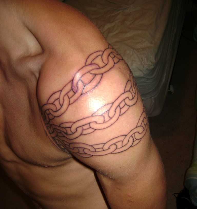 Tatuagem no ombro de um cara em forma de uma cadeia de