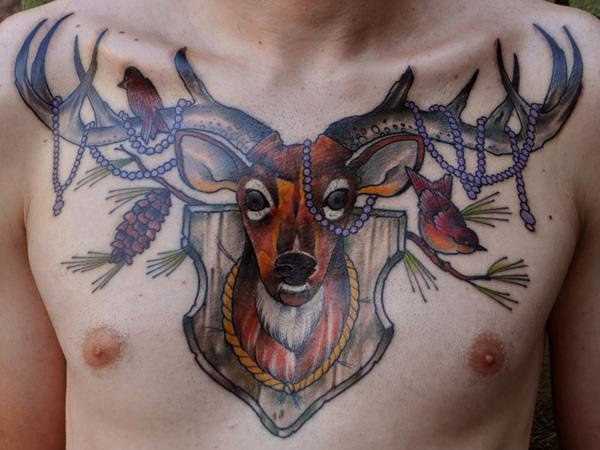Tatuagem no peito de um cara - de- veado, e as aves