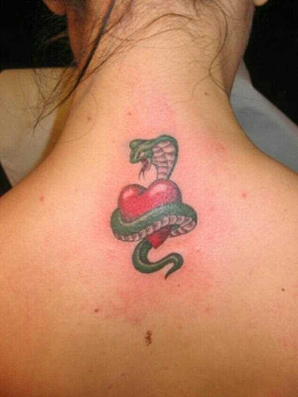 Uma tatuagem em forma de cobra e o coração na coluna vertebral de uma menina
