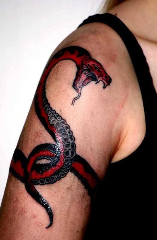Uma tatuagem em forma de serpente no ombro da menina