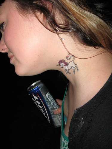 Uma tatuagem em forma de um unicórnio no pescoço de uma menina